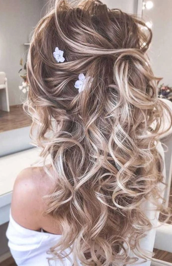 Elegant low updo with textured messy finish for bridal looks Messy textured low bridal updo hairstyle perfect for weddings