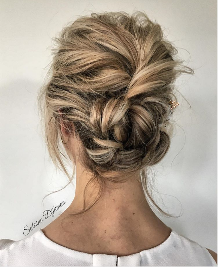 Elegant messy textured low bridal updo hairstyle perfect for brides on their wedding day Messy textured low bridal updo with loose tendrils for an elegant wedding look