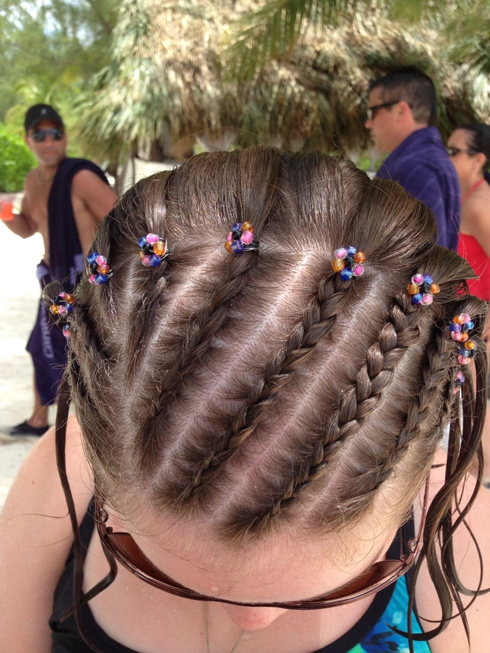 Mexican bridal braided hair styled with intricate floral accents for a wedding day