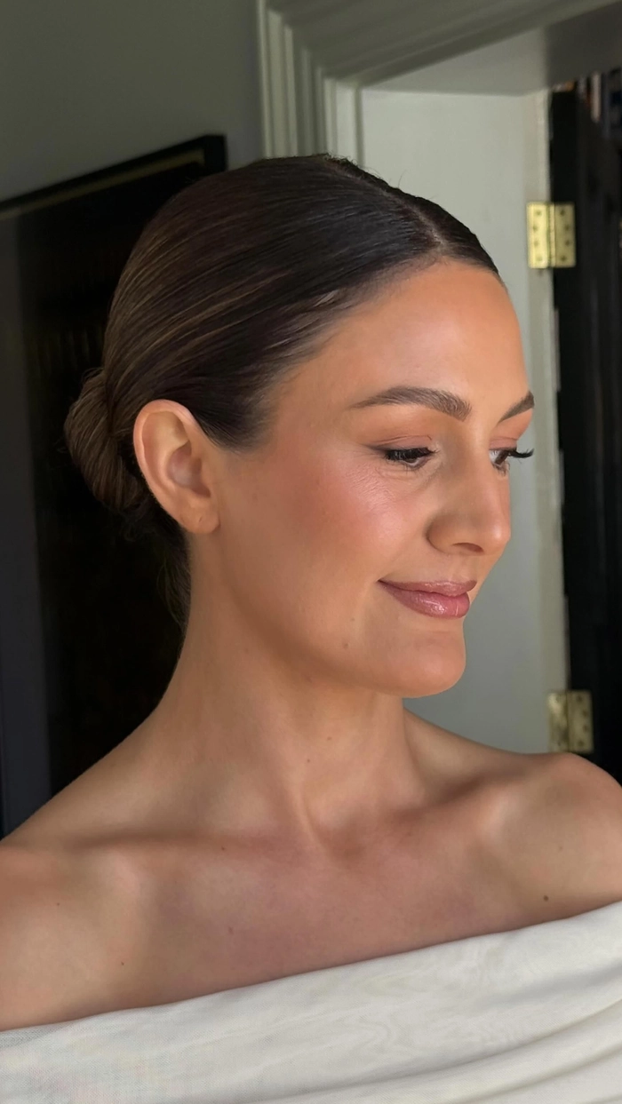 Wedding Hairstyles Gallery Image 7 showcasing a sleek bridal bun style Elegant modern minimalist bridal bun with delicate floral accents