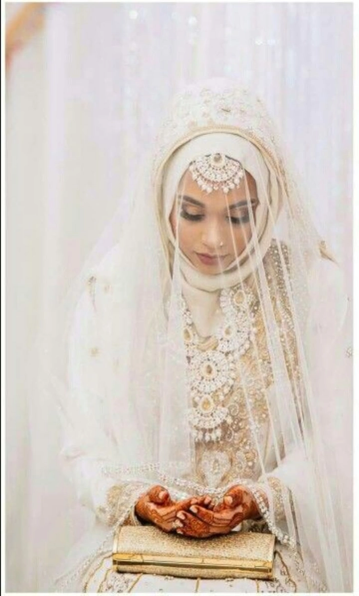 Muslim bridal hair styled elegantly under a delicate white hijab for a wedding ceremony