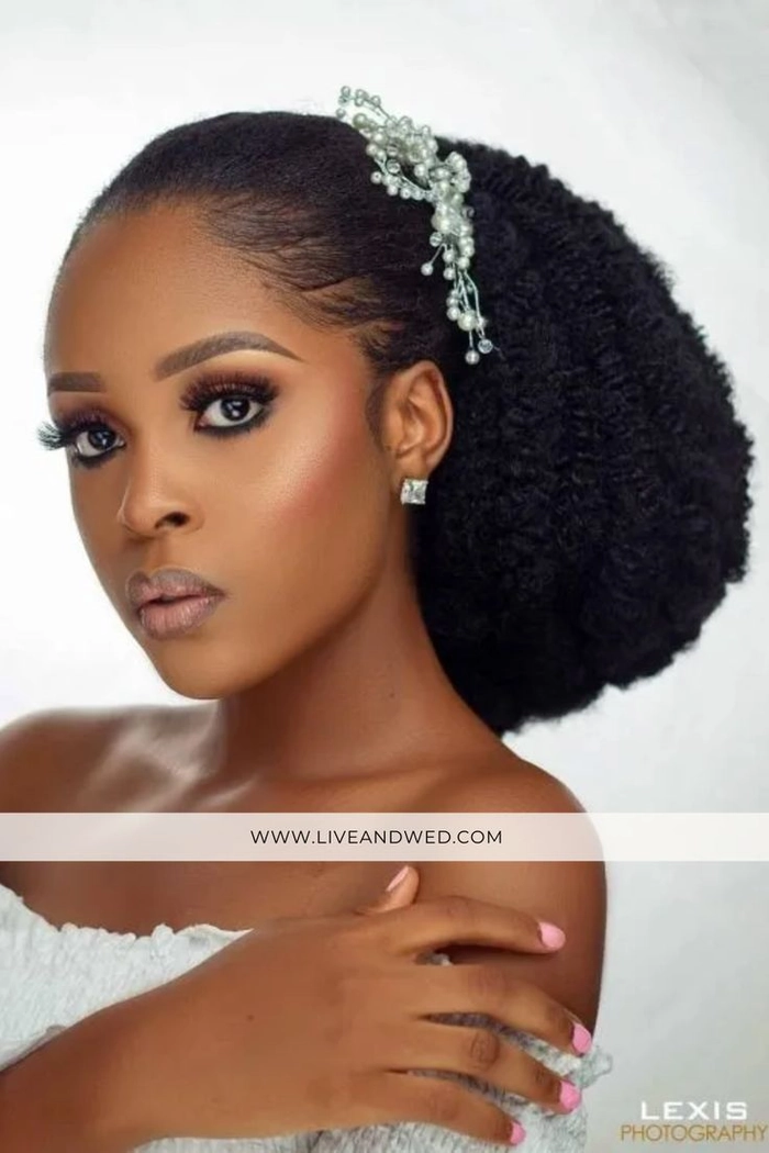 Elegant natural black hair bridal look with intricate curls and floral accessories