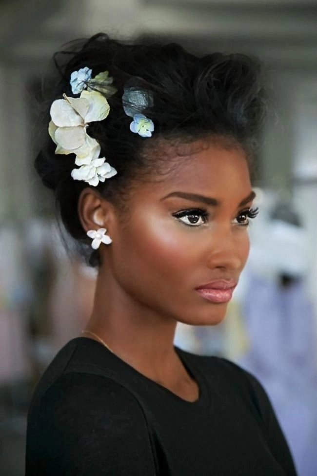 Elegant natural black hair bridal look with delicate floral accents