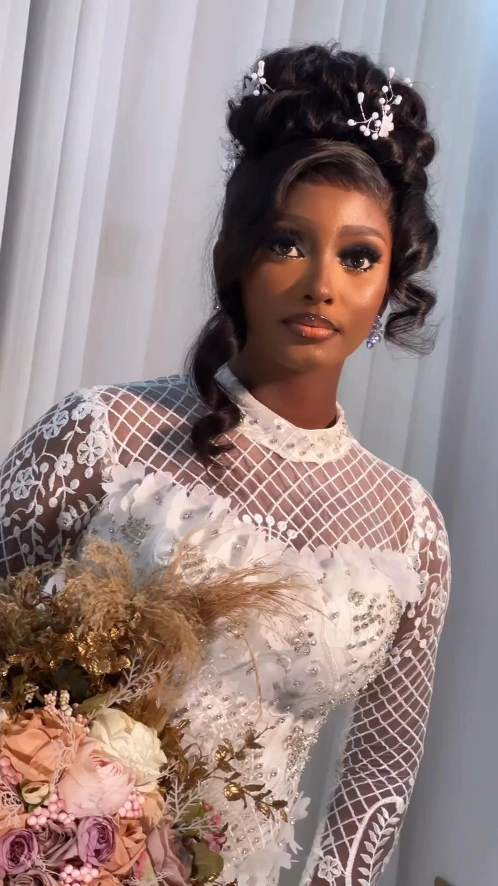 Elegant natural black hair bridal look with intricate twists and soft curls
