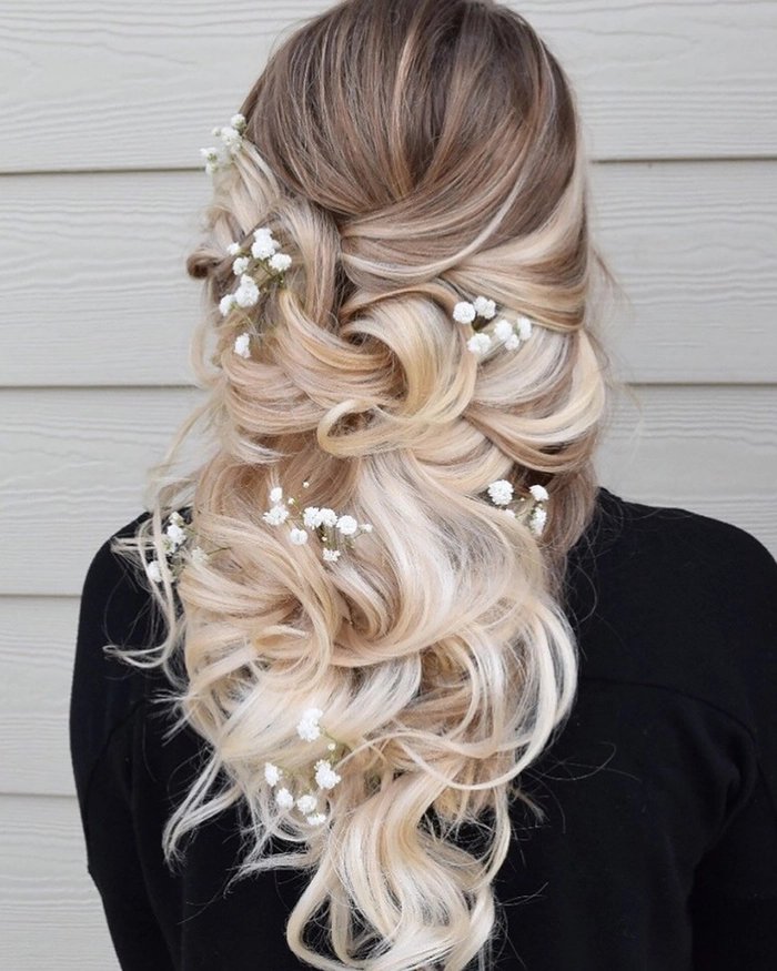 Elegant outdoor rustic wedding bridal hair with soft curls and floral accents