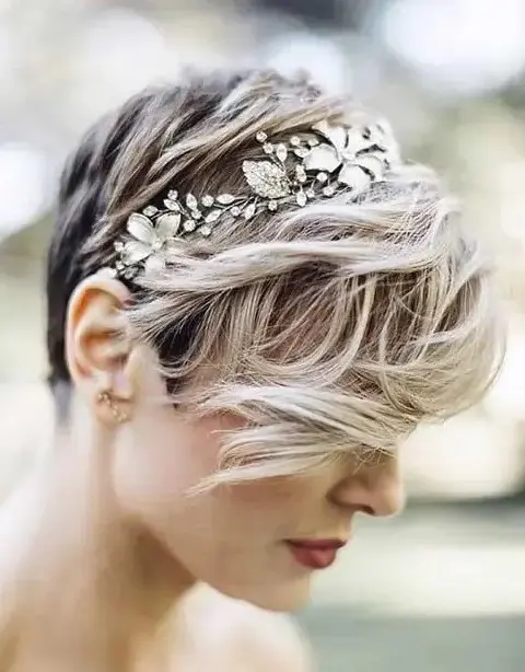 Elegant wedding hairstyle featuring pixie cut with floral hair ornaments Pixie cut styled with delicate wedding hair accessories for a bride