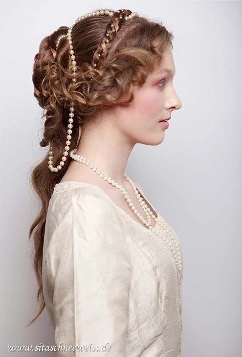Romantic bridal hairstyle inspired by renaissance fair fashion perfect for weddings Elegant renaissance fair wedding hair with intricate braids and floral accents