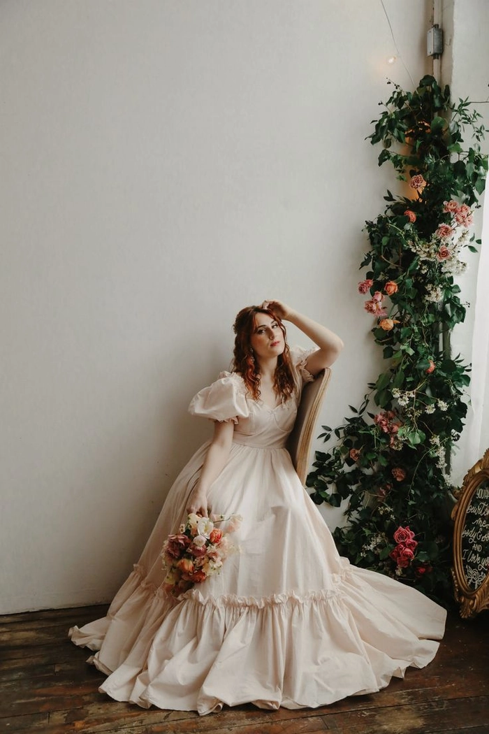 Soft romantic cottagecore wedding hair style with floral accents