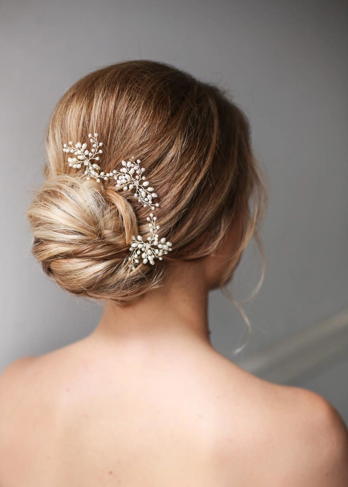 Elegant bridal hairstyle featuring a relaxed chignon perfect for weddings Romantic loose chignon wedding hair with soft tendrils framing the face
