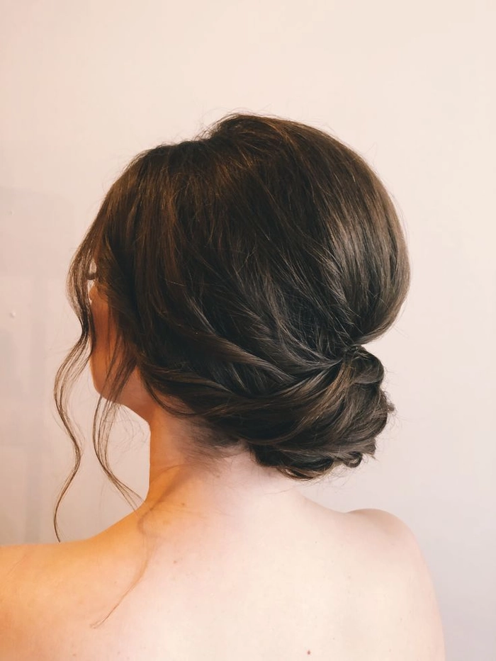 Elegant and timeless romantic loose chignon perfect for wedding day hairstyles Romantic loose chignon wedding hair styled with soft curls and delicate floral accents
