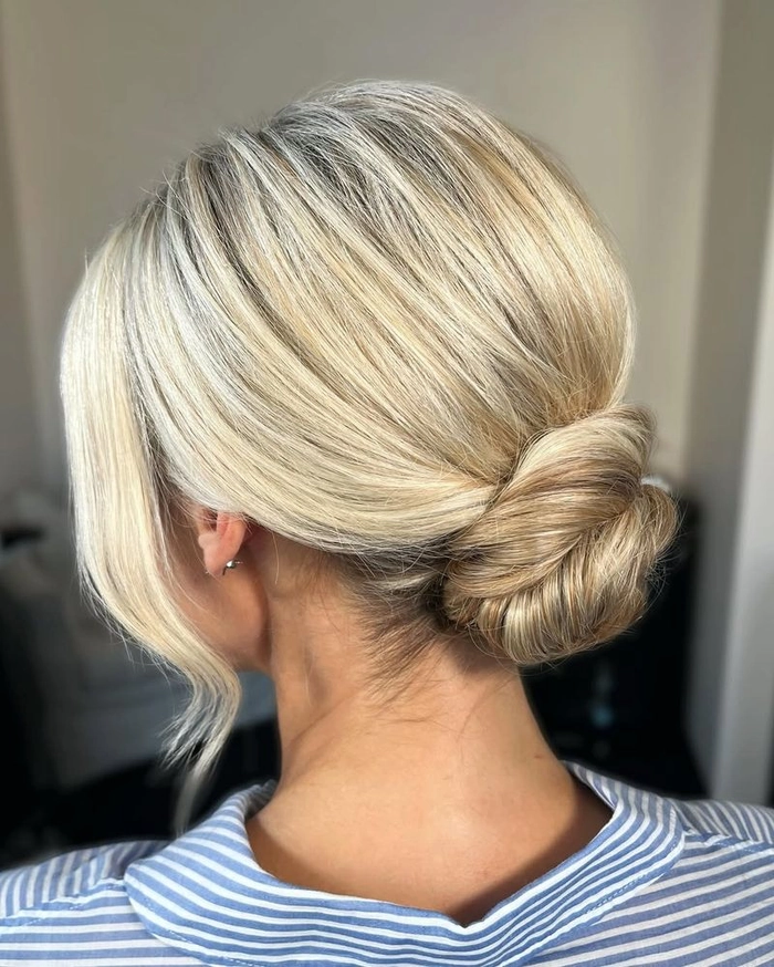 Elegant and timeless romantic loose chignon for a perfect bridal look Romantic loose chignon wedding hair with soft tendrils framing the face