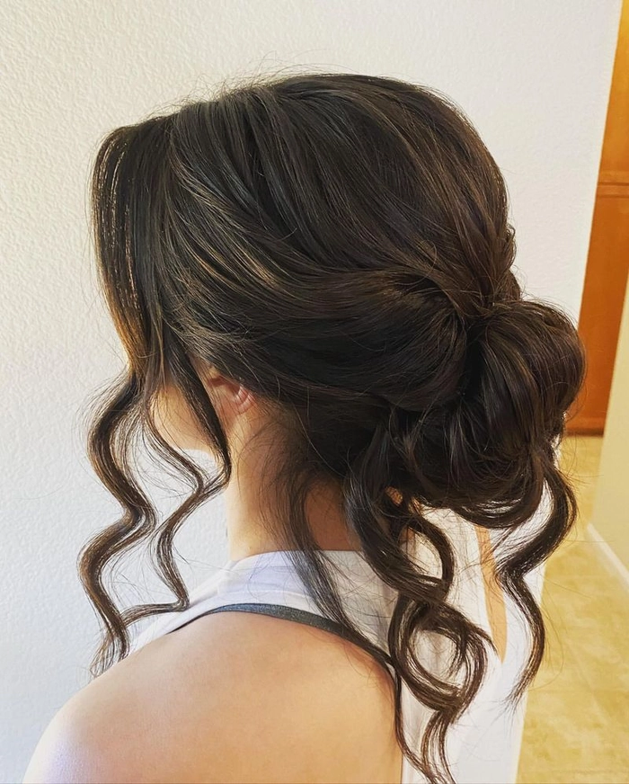 Elegant loose chignon hairstyle perfect for a romantic wedding look Romantic loose chignon wedding hair styled with soft curls and delicate floral accents