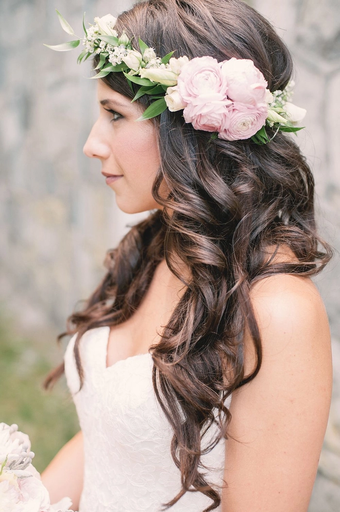 Outdoor rustic wedding bridal hair styled with loose waves and floral accents