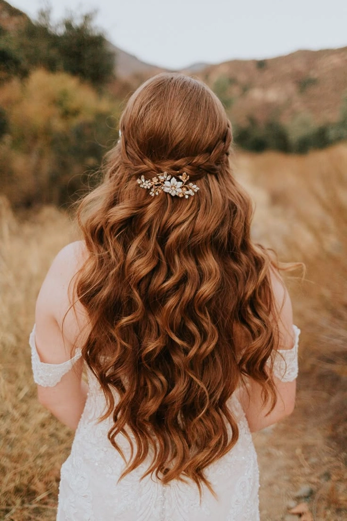 Bride with outdoor rustic wedding bridal hair styled with loose curls and floral accents