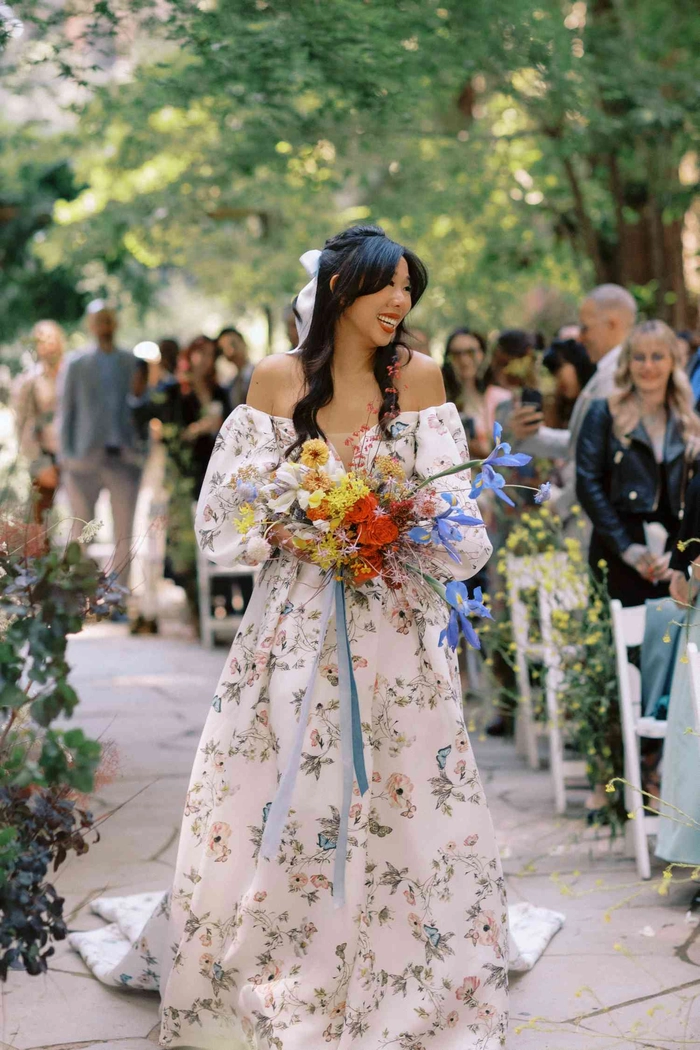 Soft curls adorned with wildflowers showcasing cottagecore wedding hair styles