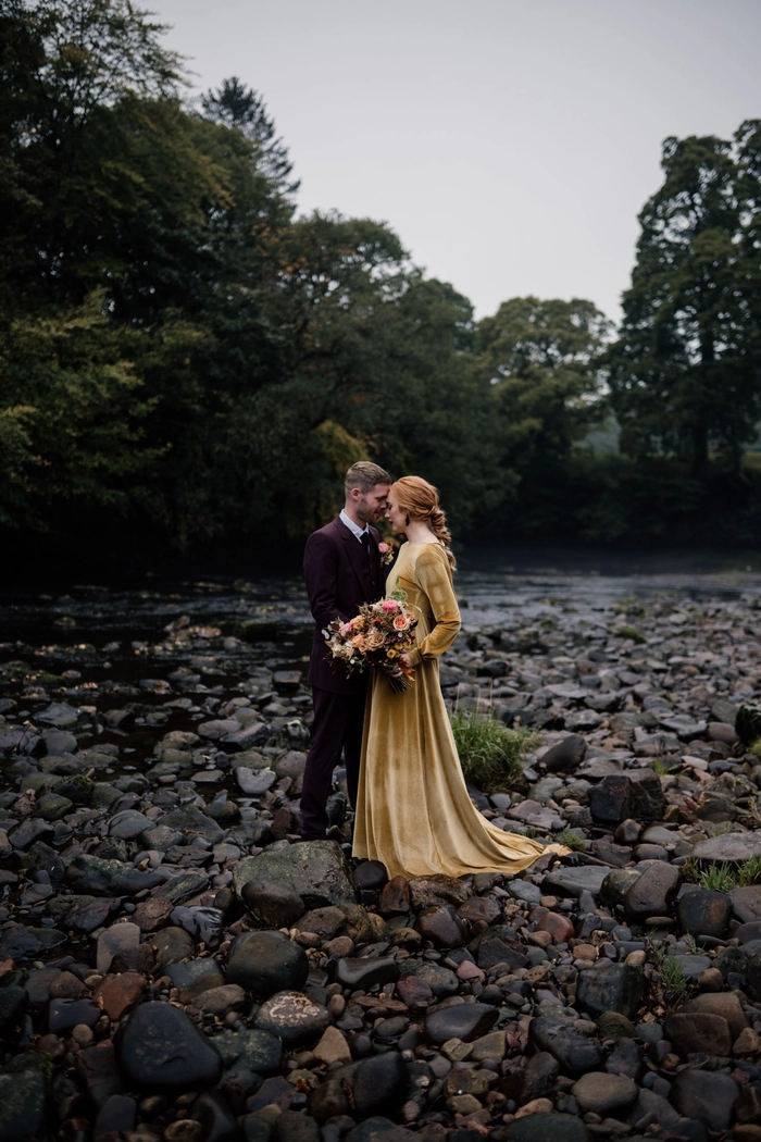 Soft waves adorned with fresh flowers for cottagecore wedding hair styles