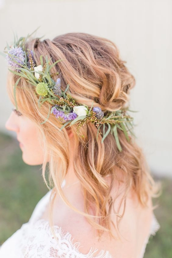 Spring garden wedding floral hair with delicate blossoms woven into soft curls