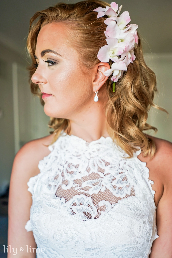 Spring garden wedding hairstyle adorned with delicate pink and white flowers