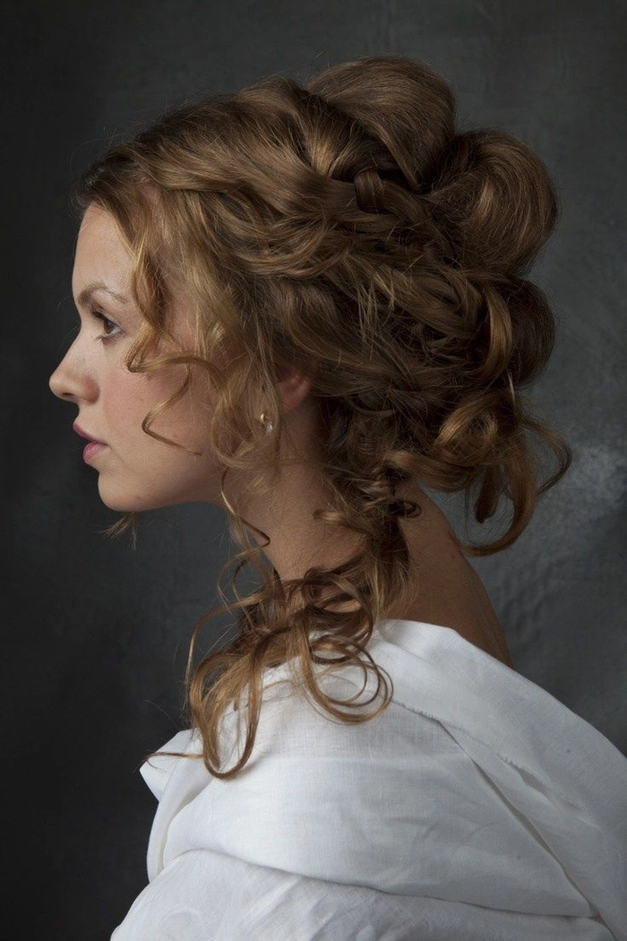 Victorian era inspired bridal hair with intricate curls and floral accessories