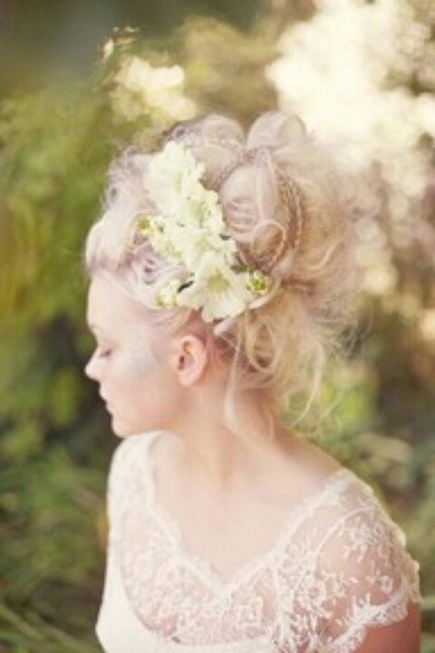 Elegant Victorian era inspired bridal hair with intricate braids and delicate floral accents