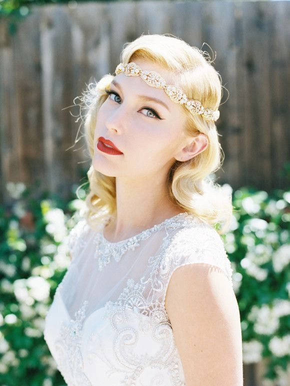 Elegant Victorian era inspired bridal hair with intricate curls and floral accents