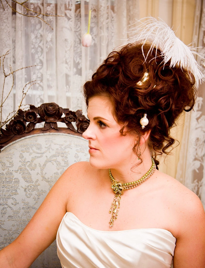 Victorian era inspired bridal hair with intricate curls and floral accents