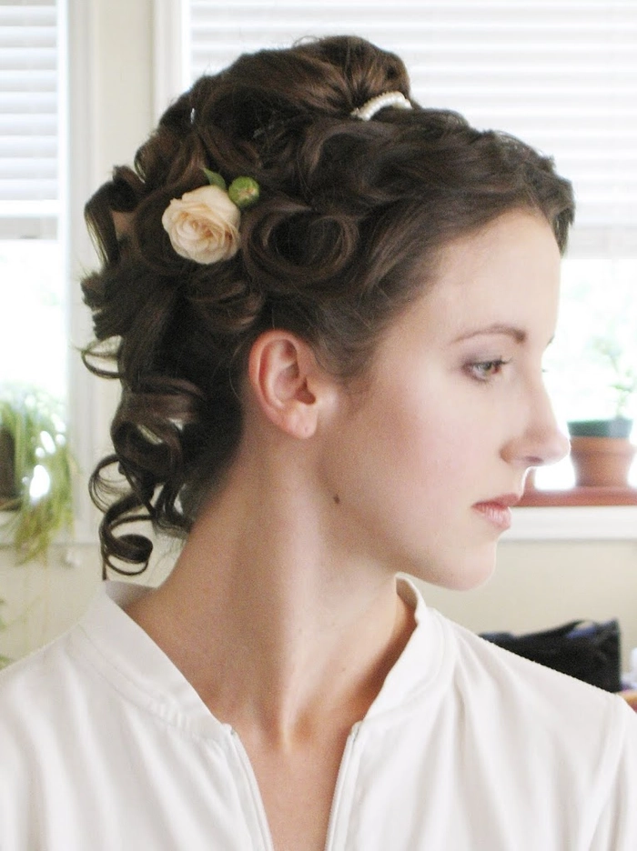 Elegant Victorian era inspired bridal hair with intricate curls and floral accents