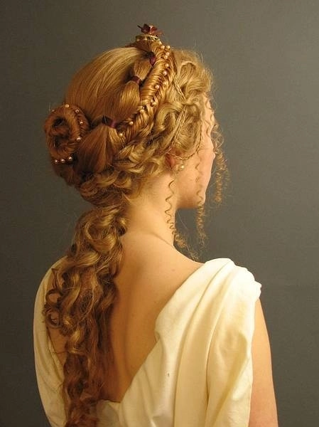 Victorian era inspired bridal hair styled with intricate curls and delicate floral accents