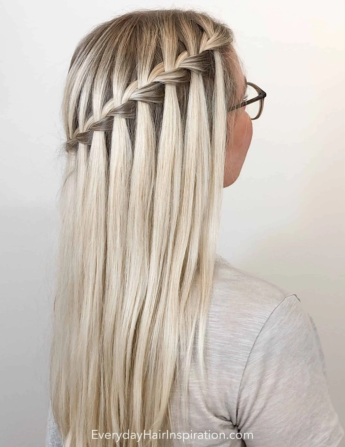 Beautiful waterfall braid hairstyle perfect for bridal looks and special occasions Elegant waterfall braid wedding hair styled with delicate floral accents