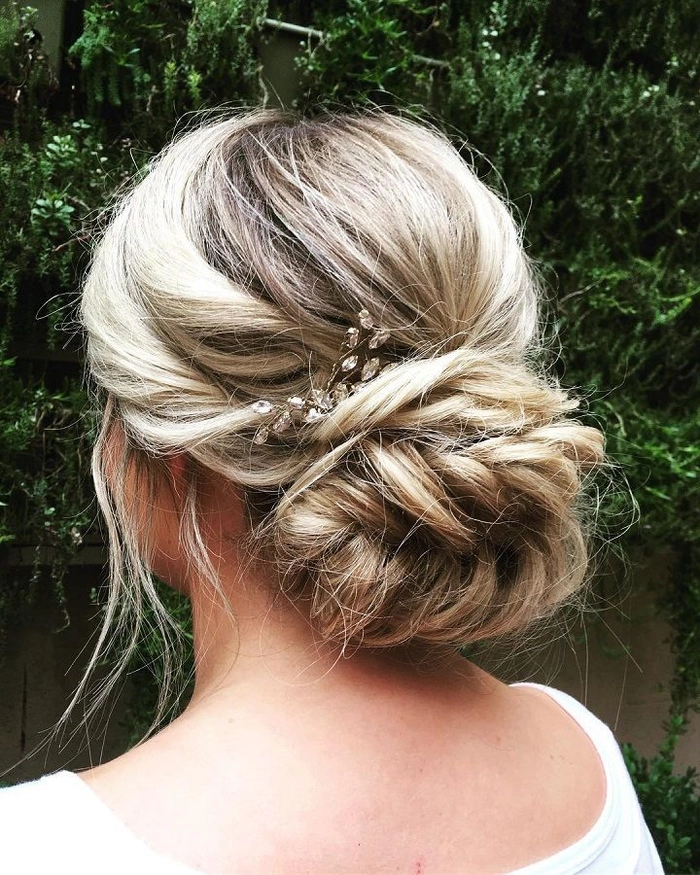 Stunning fishtail braid updo perfect for bridal hairstyles Wedding Hairstyles image 2 Elegant wedding hair fishtail braid updo with delicate floral accents