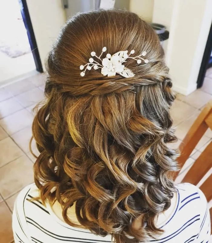 Beautiful medium-length hair styled for wedding guests with romantic waves and accessories Elegant wedding guest hairstyle for medium hair with soft curls and floral accents