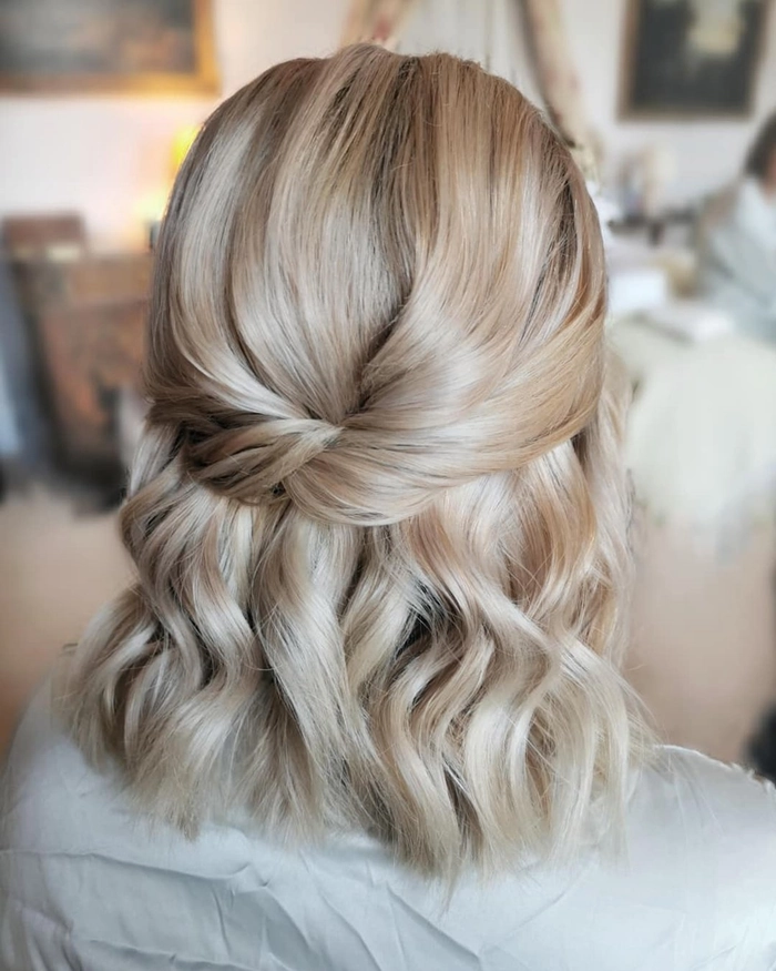 Chic and romantic medium hair wedding guest hairstyle idea Elegant wedding guest hairstyle for medium hair with soft curls