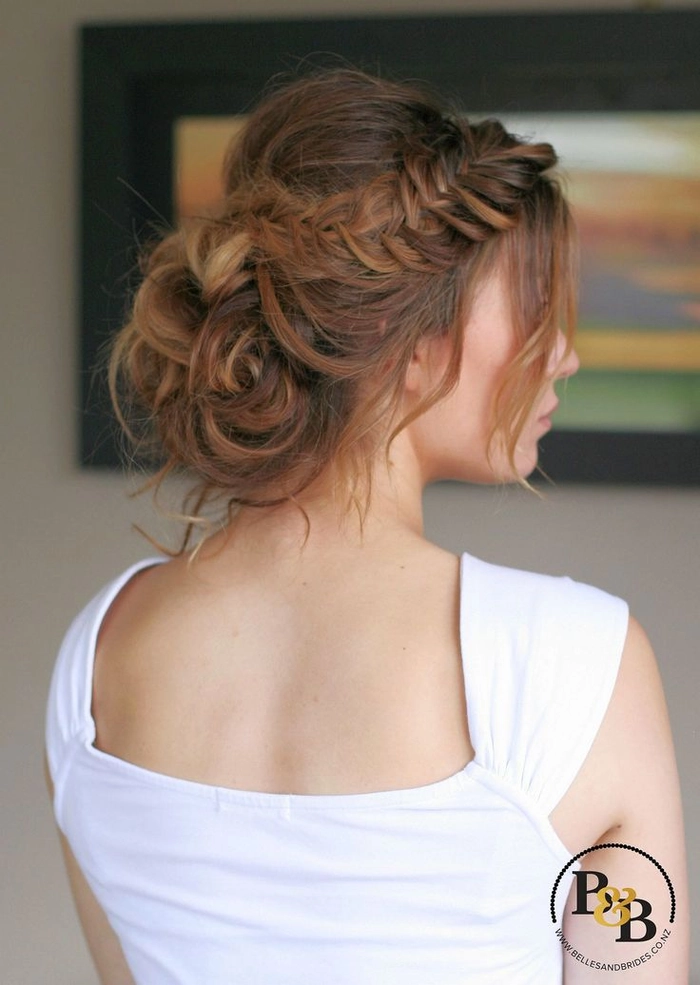 Classic fishtail braid updo perfect for sophisticated wedding hairstyles Bride showcasing an elegant wedding hair fishtail braid updo adorned with delicate floral accents