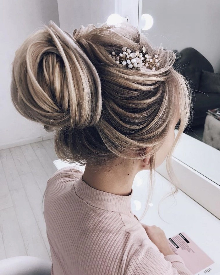 Chic and romantic bridal hairstyle featuring a sophisticated hair knot updo Elegant wedding hair knot updo with delicate floral accents for brides