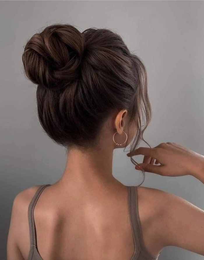 Stunning bridal hairstyle featuring a romantic knot updo for wedding day glamour Elegant wedding hair knot updo with soft curls and delicate accessories