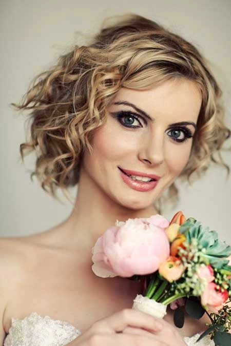 Wedding hair for short layers styled elegantly with soft curls and delicate accessories