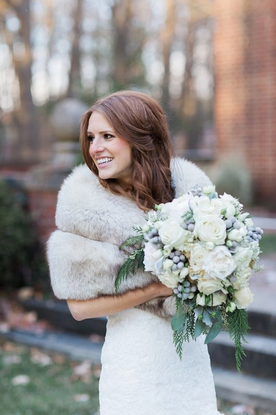 Elegant winter wedding hairstyle featuring faux fur accessories for a cozy bridal look
