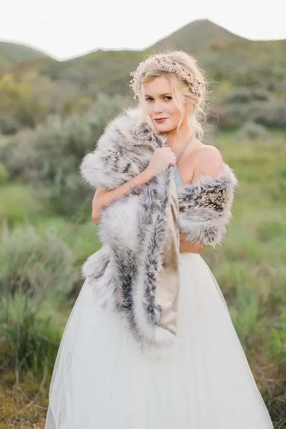 Elegant winter wedding hairstyle featuring faux fur accessories for a cozy bridal look