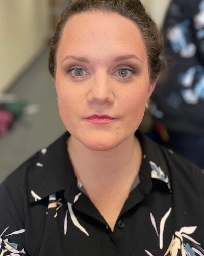 Broadcaster applying quick camera ready hair touchup before going live