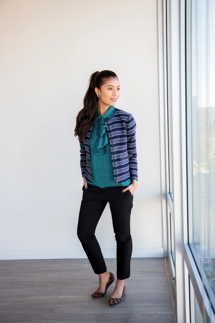 A professional woman showcasing chic top knot variations suitable for business casual work environments