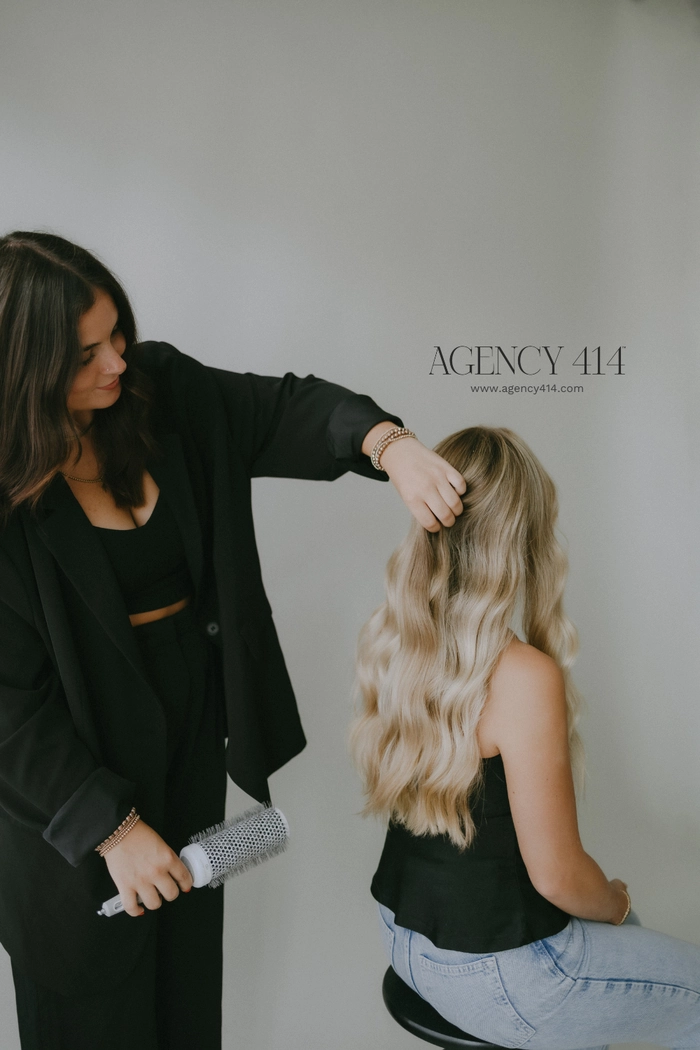 Creative agency work hairstyle for fashion industry trendsetters Fashion professional showcasing a creative agency hair trend with a sleek, modern updo