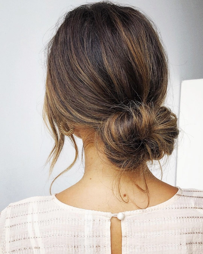 Effortless messy bun hairstyle that looks professional for the workplace