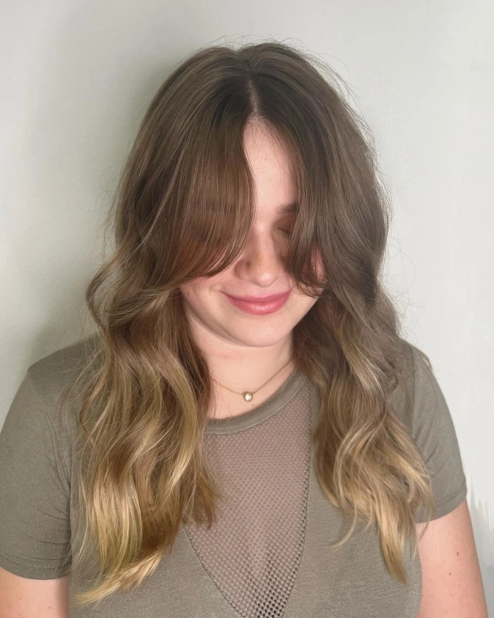 Face framing layers styled for a round face shape in a professional office environment