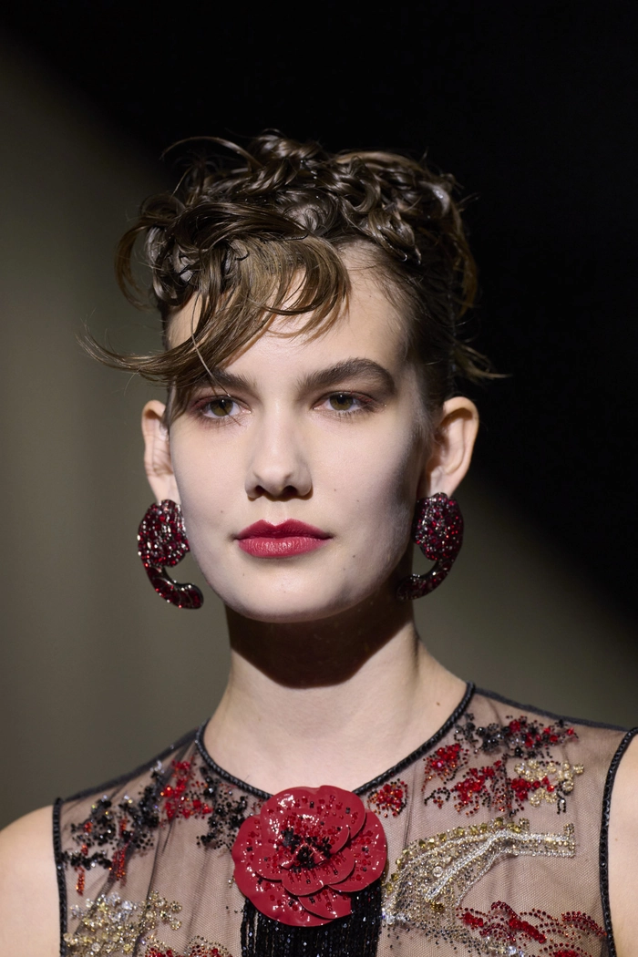 A professional fringe hairstyle covering the forehead with sleek, work-appropriate styling