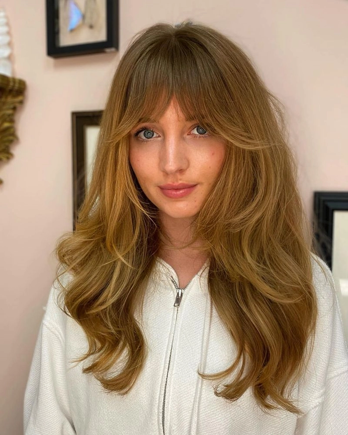 A neat and polished work hairstyle with a full fringe covering the forehead
