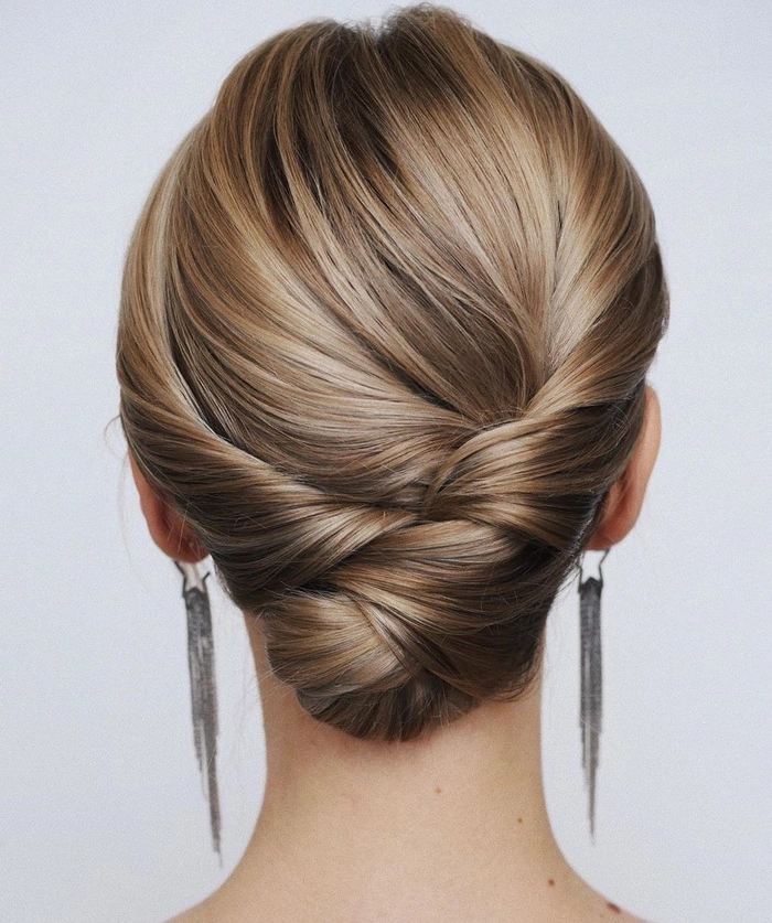A petite woman in business attire wears a voluminous updo that adds height to her look