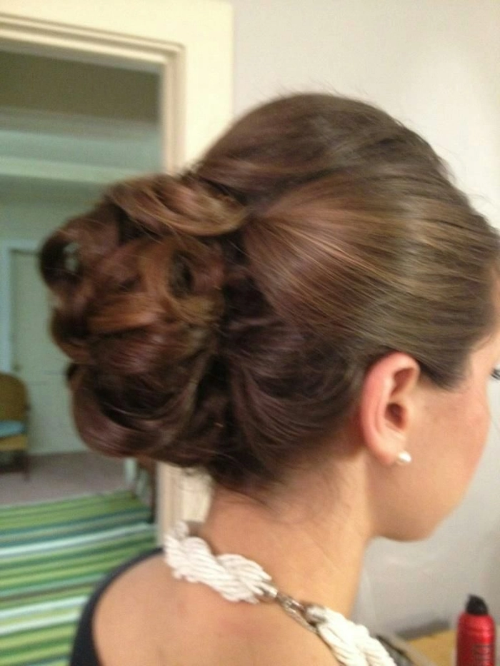 Petite professional woman with a sleek height-adding updo hairstyle