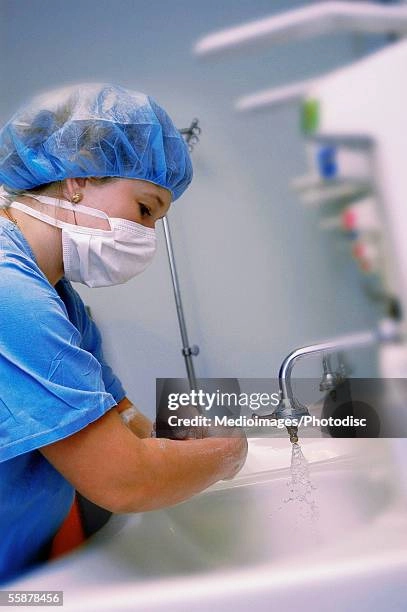 Healthcare worker demonstrating a hygienic hair tucking method for a safe work hairstyle