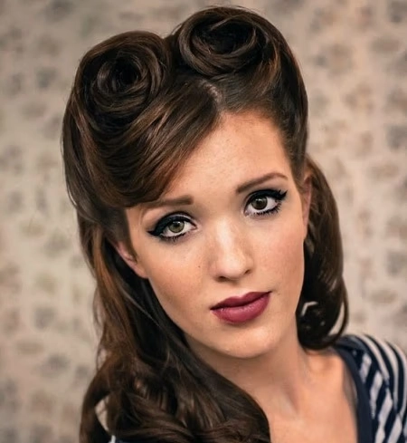 Woman with neatly rolled vintage victory rolls hairstyle suited for a retro themed work event