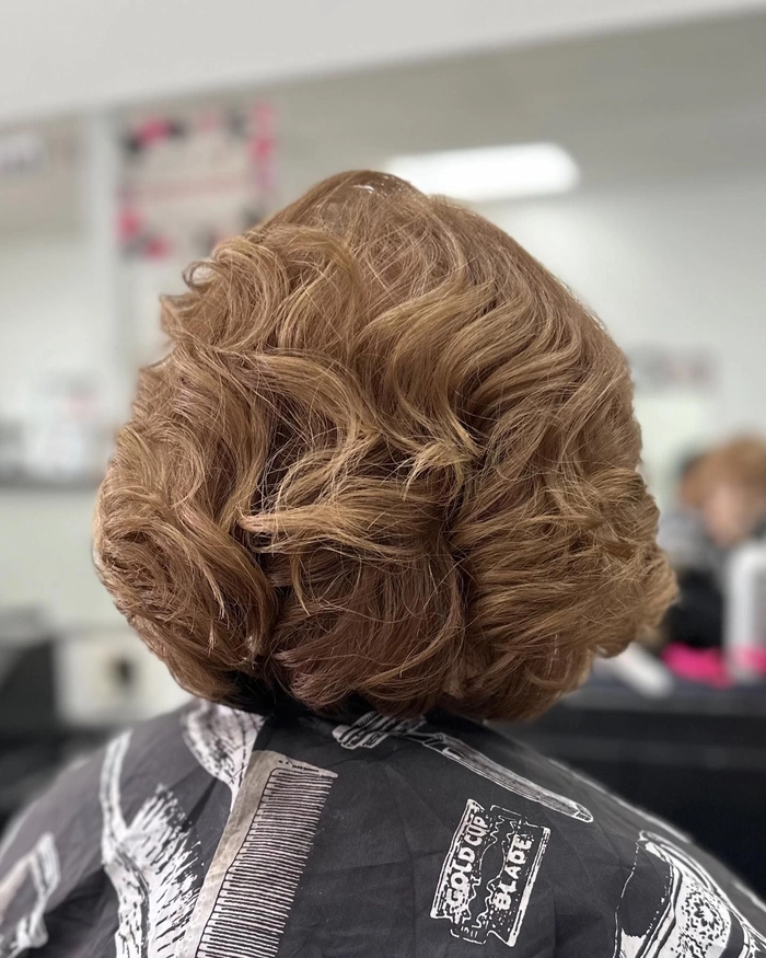 Mature businesswoman with a classic roller set hairstyle in a professional office environment